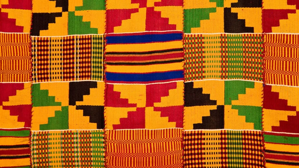Woven Ghanaian Kente cloth, gold, red, green, blue, and black geometric strips.